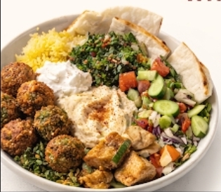 Medbox bowl with falafel, hummus, saffron rice, and fresh vegetables